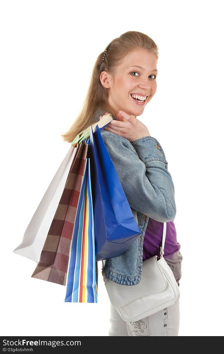 Young girl with purchases on white background