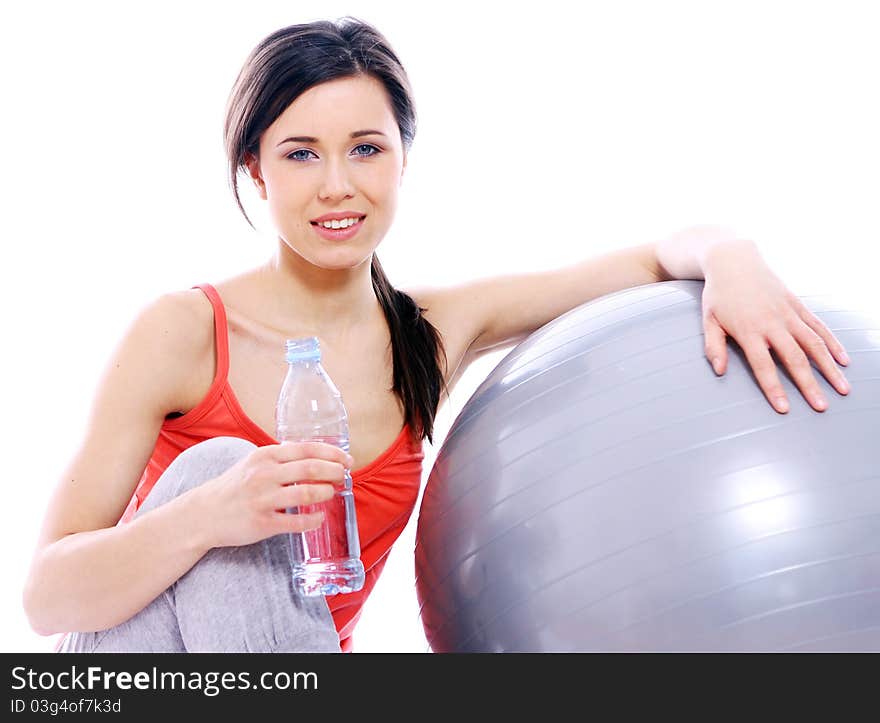 Young and beautiful girl with bottle of mineral water in gym