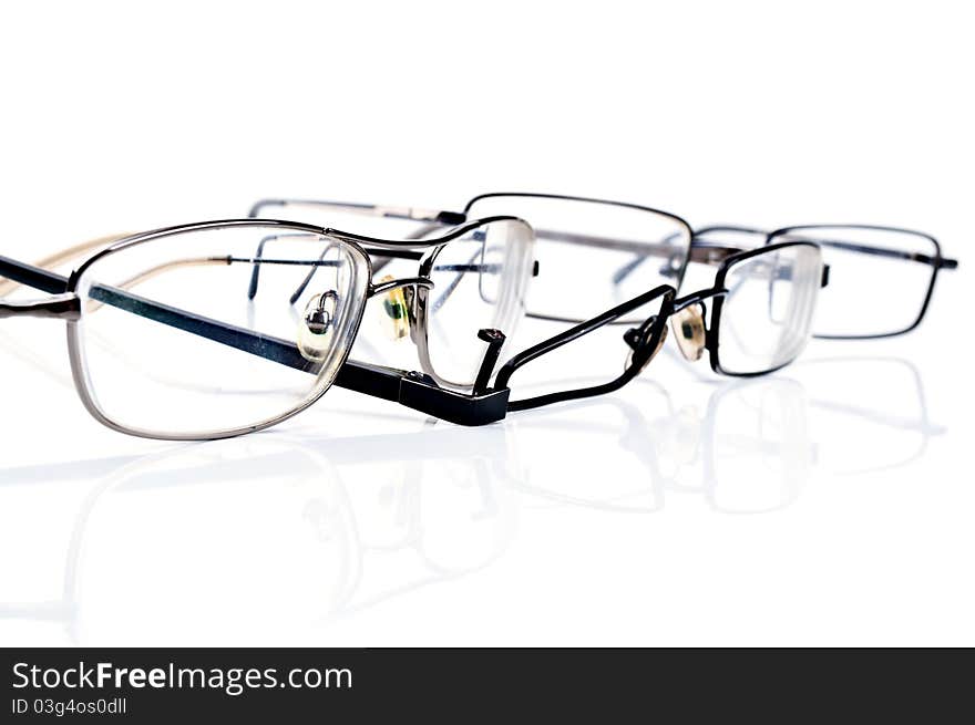 Broken black eyeglasses isolated on a white background