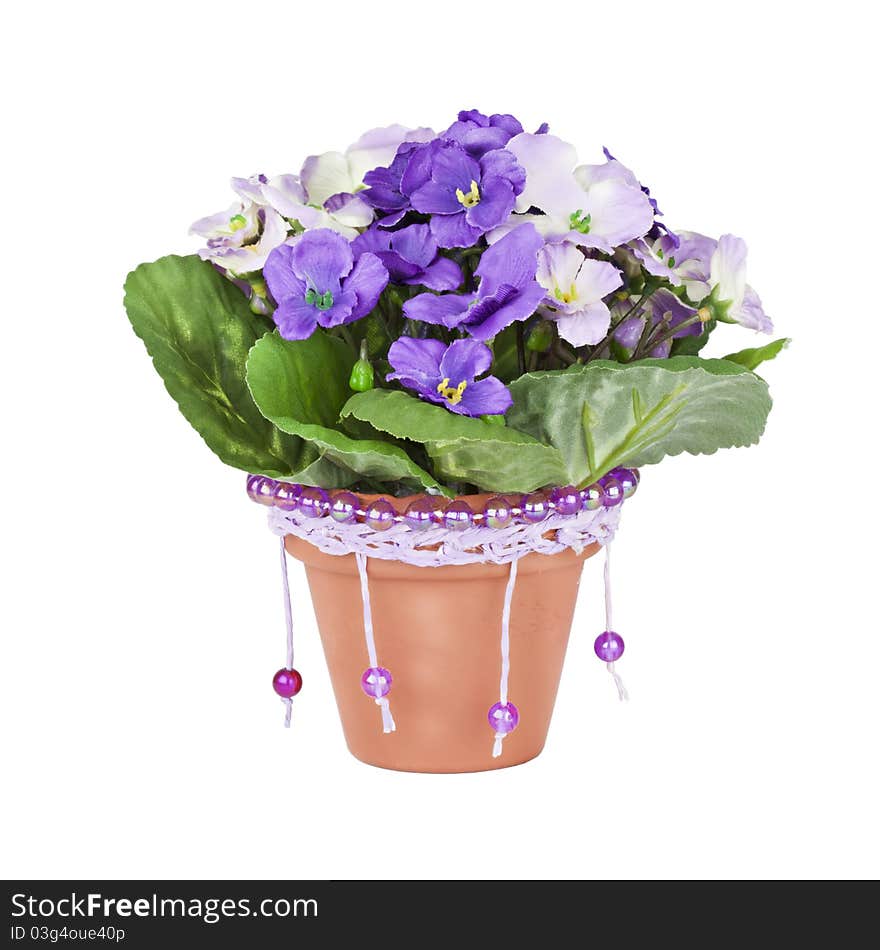 Artificial violet in ceramic pots, decorated with beads, handmade,  isolated on a white background.