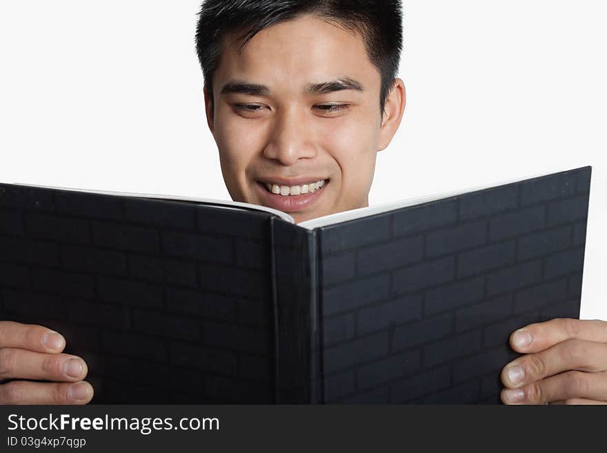 A man looking at a book on a white background. A man looking at a book on a white background