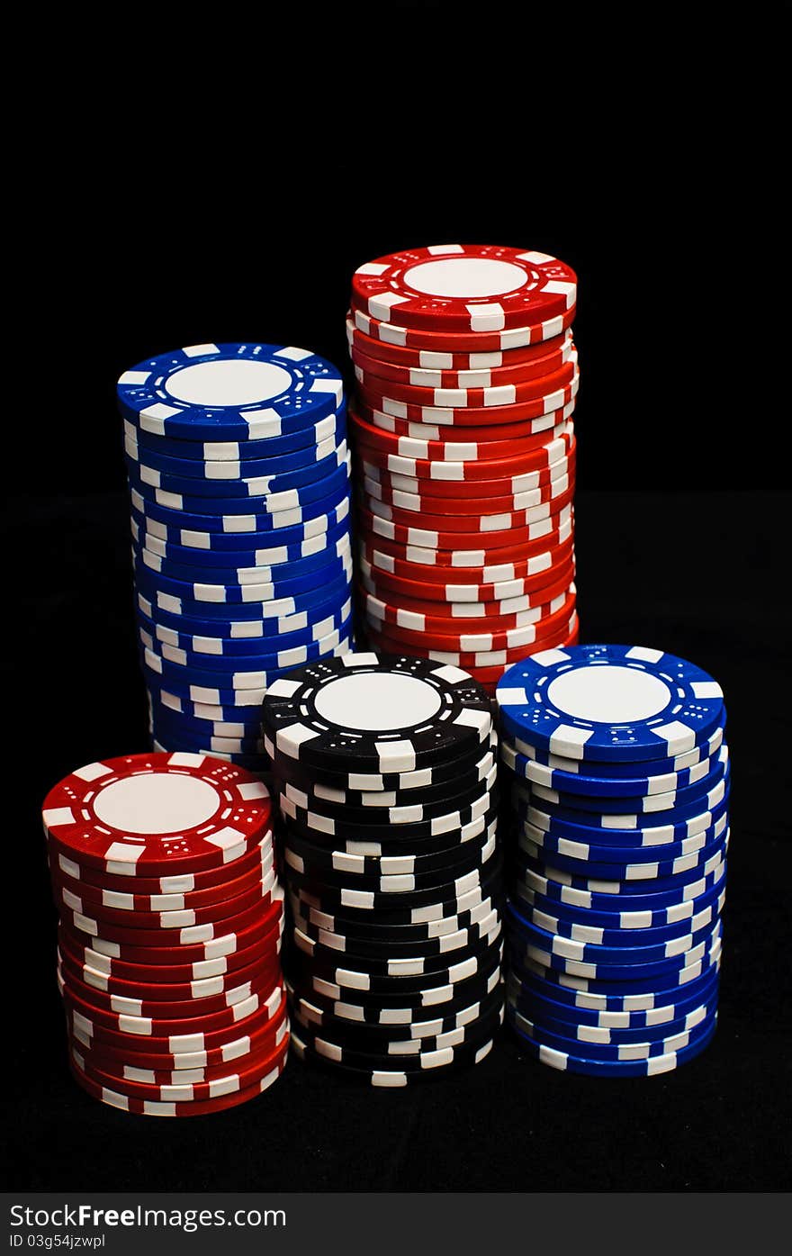 Stacks of gambling chips on the black background