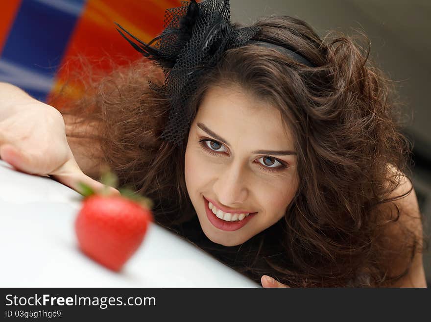 Young woman with red strawberry