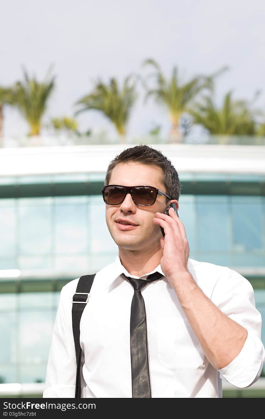 Manager speak on phone across office building