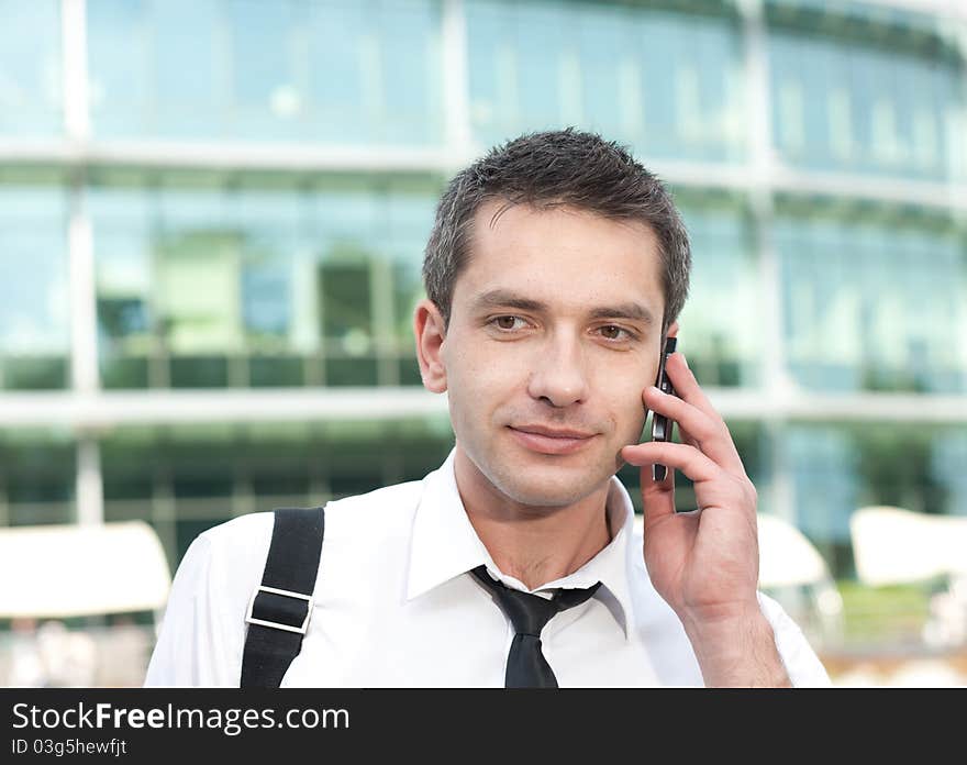 Manager speak on phone across office building