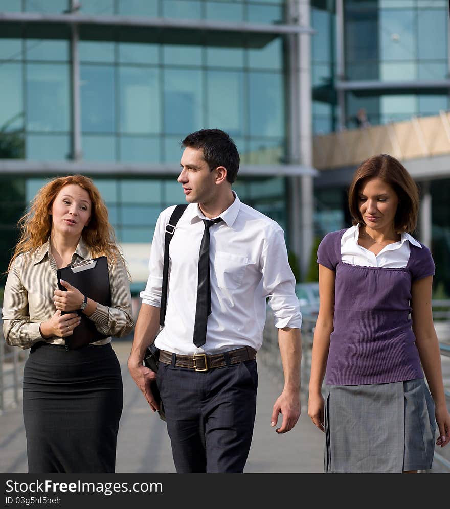 Group of workers walk across office building. Group of workers walk across office building