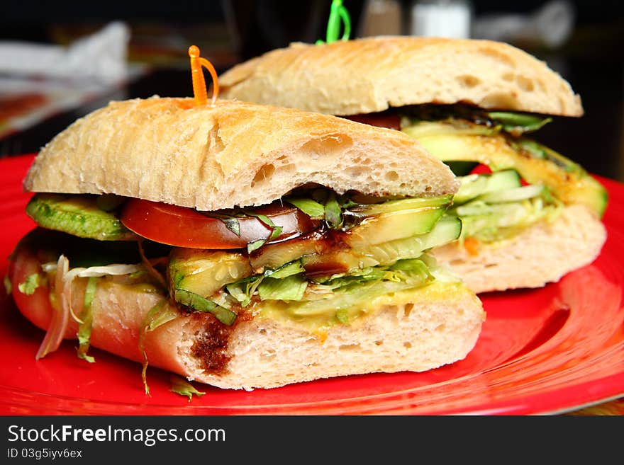 Sandwiches with cucumbers and tomatoes on a Red Plate. Sandwiches with cucumbers and tomatoes on a Red Plate