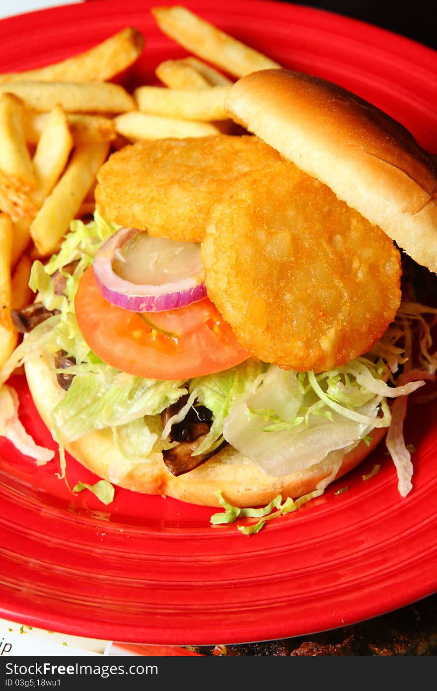 Sandwiches with onion, fried potato and tomato on a Red Plate. Sandwiches with onion, fried potato and tomato on a Red Plate