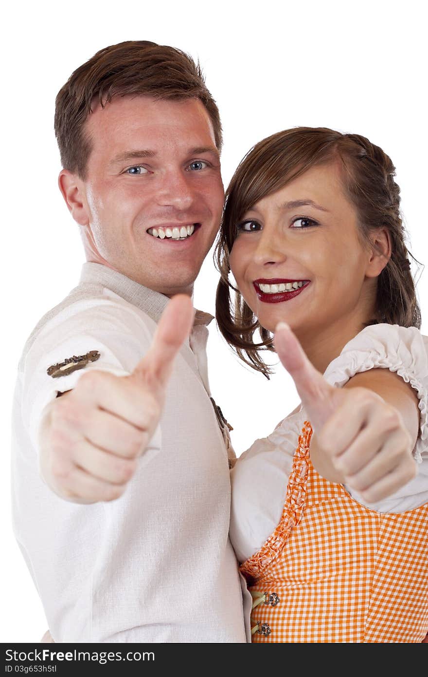 Happy Bavarian man and woman with dirndl hold thumbs up.Isolated on white background. Happy Bavarian man and woman with dirndl hold thumbs up.Isolated on white background.