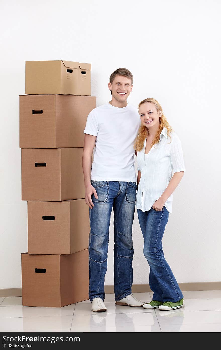 Young couple with boxes indoors. Young couple with boxes indoors