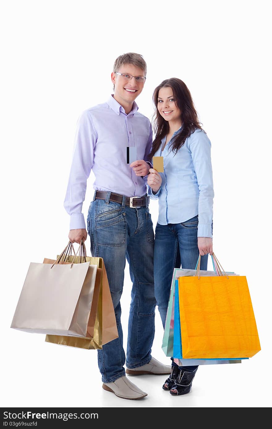 Young couple with credit cards and shopping on a white background