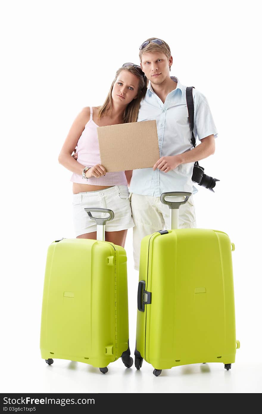 Upset couple with suitcases and empty sign on white background. Upset couple with suitcases and empty sign on white background