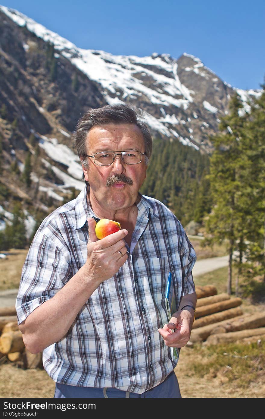 Retired Man Hiking In The Alps