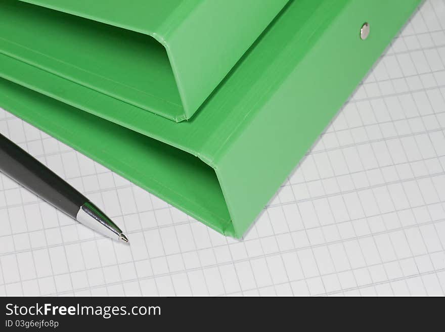 Green folders with pen