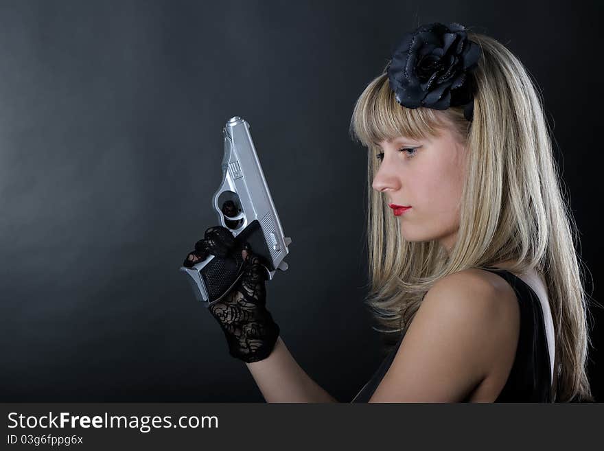 Gangster woman with pistol in black