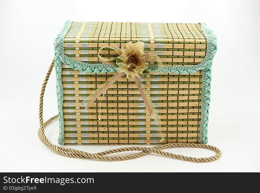 A square child bag made of straw on the white background