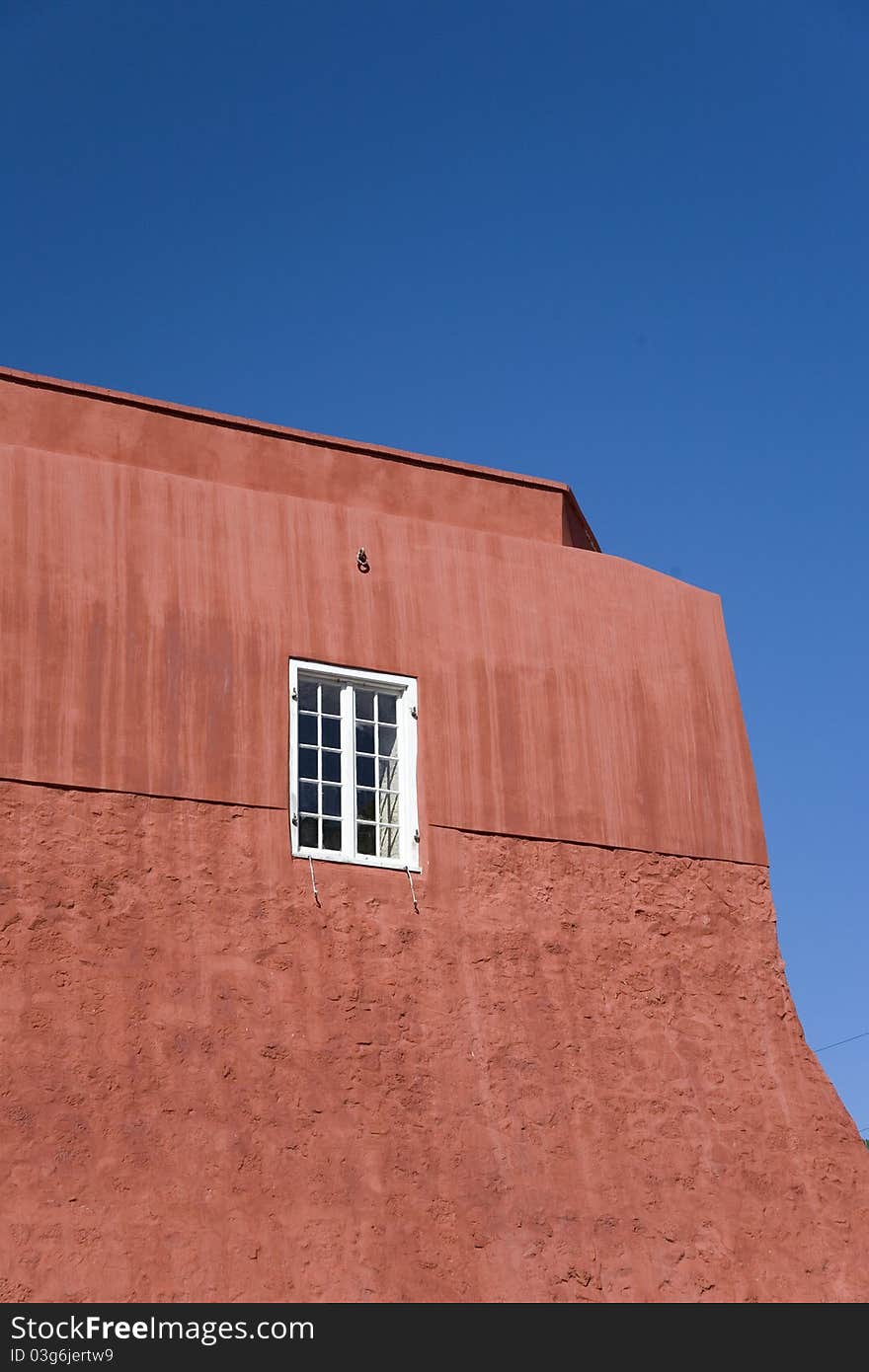 Big red building under Caribbean blue sky