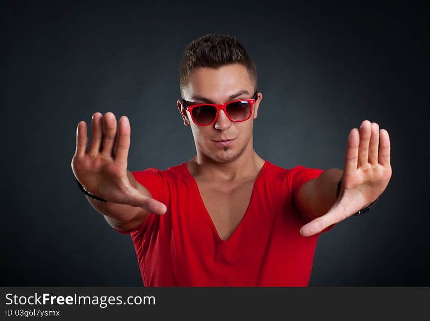 Handsome man making a stop sign with his hands, isolated