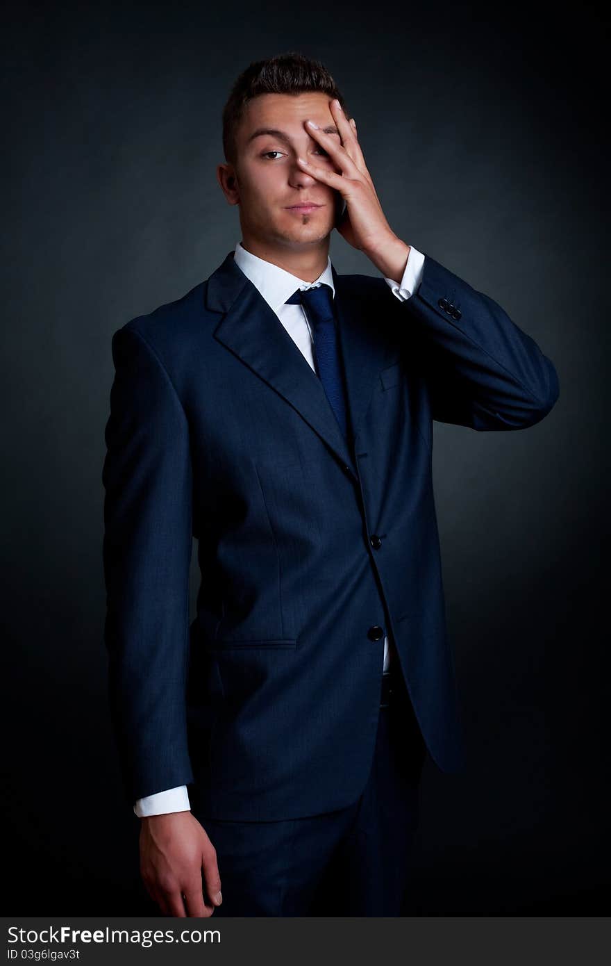 Portrait of handsome stylish man in elegant blue suit