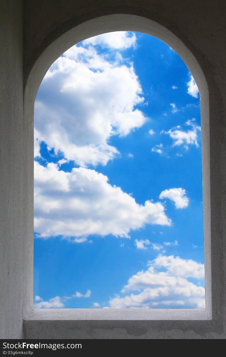 Window frame exposing blue sky and white clouds. Window frame exposing blue sky and white clouds