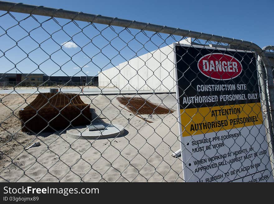 Danger-Sign at Fenced Off Construction Site in new Industrial Area. Danger-Sign at Fenced Off Construction Site in new Industrial Area.