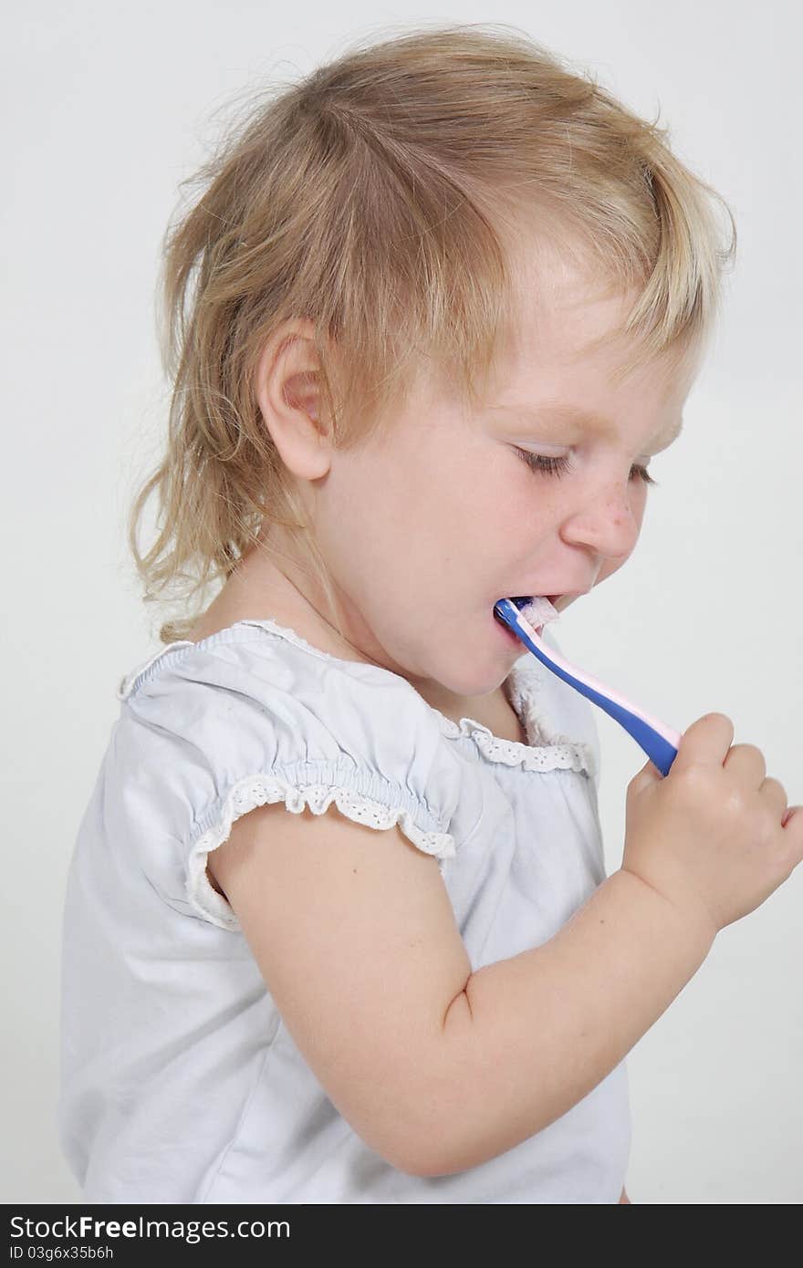 Child with toothbrush over white