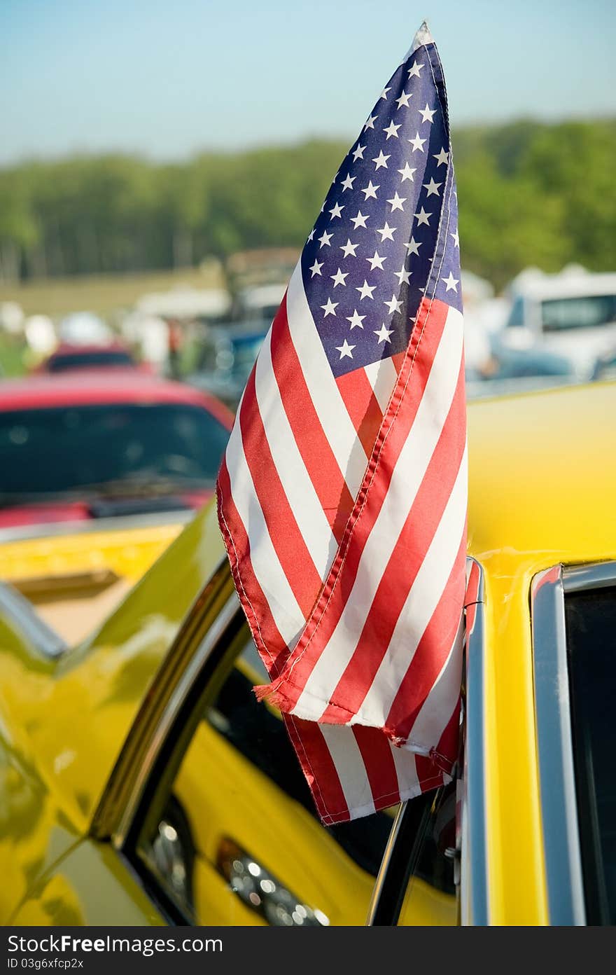 United states stars and stripes flag hanging from a vehicle door. United states stars and stripes flag hanging from a vehicle door