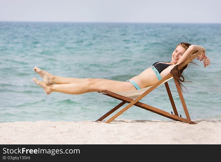 Happy woman relaxing on beach