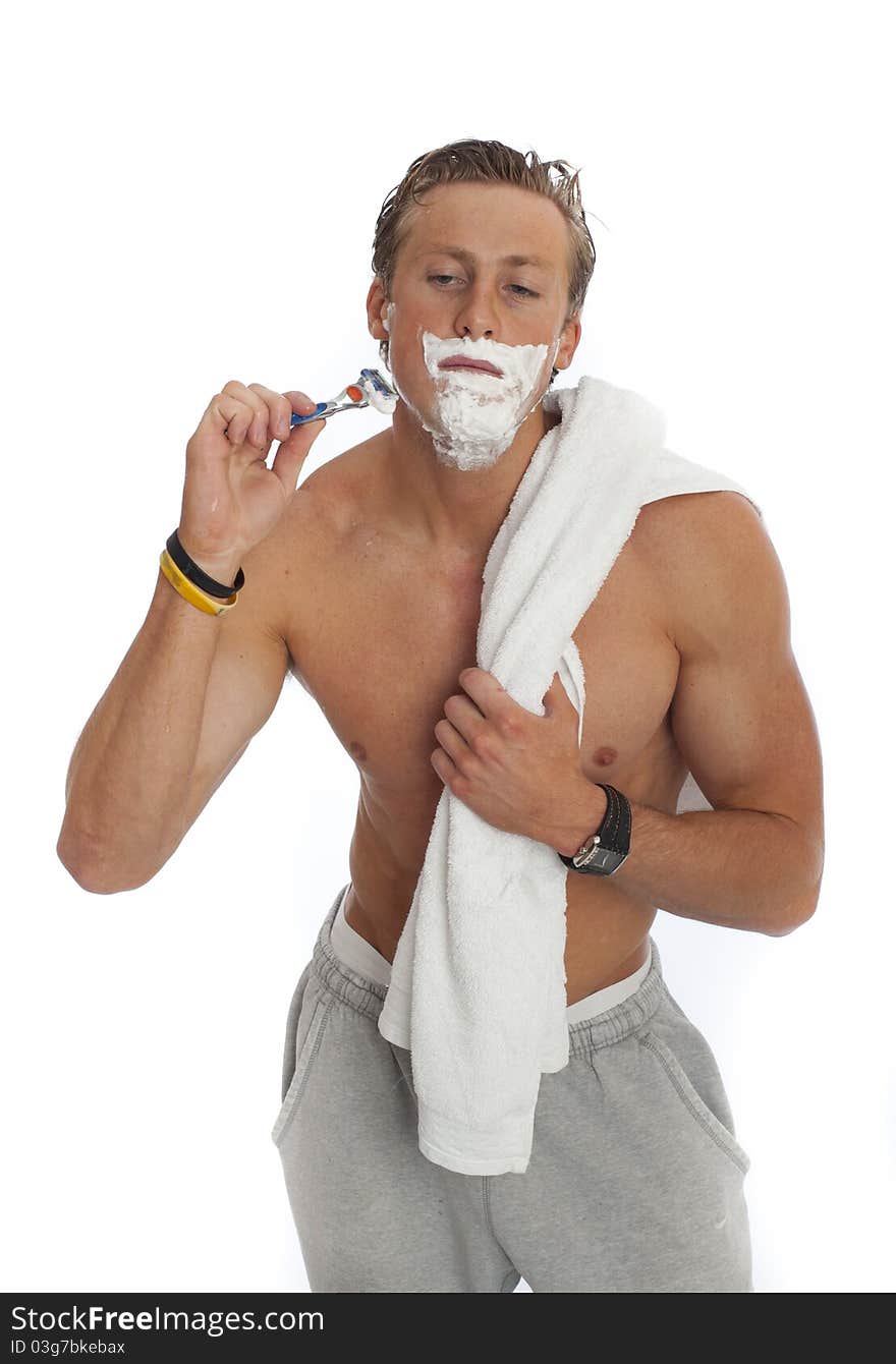 Young male shaving isolated