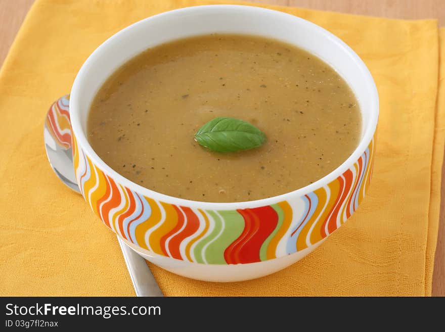 Vegetable soup with basil in a bowl