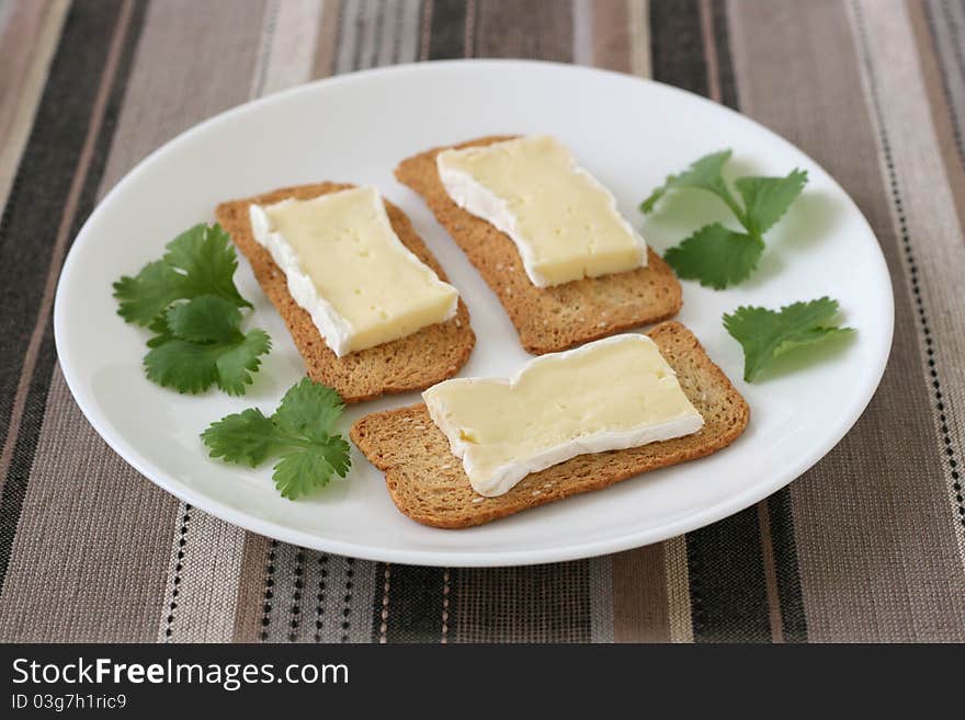 Toasts with cheese camembert on a plate