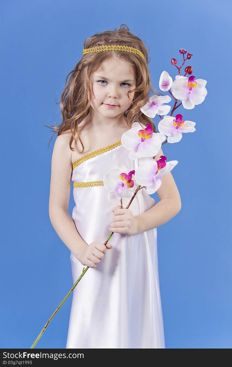 Beautiful girl in the dress of the goddess holding a flower