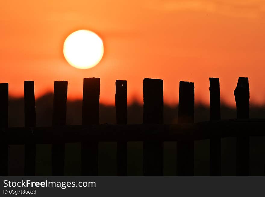 Fence silhouette and sun landscape