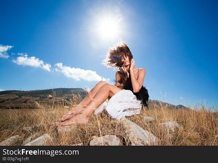 Curly romantic woman in the mountains