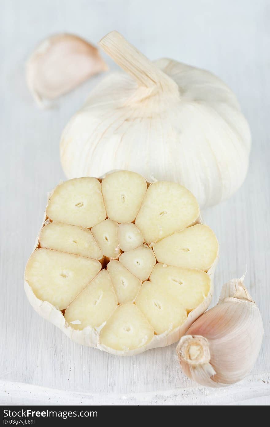 Spicy garlic on a white garden wooden table. Spicy garlic on a white garden wooden table.