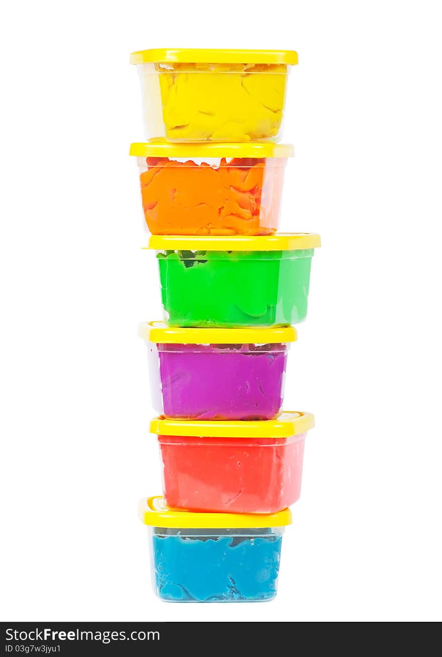 A stack of jars with plasticine of different colors