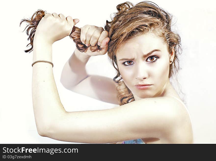 Brunette woman pulling her hair. Brunette woman pulling her hair