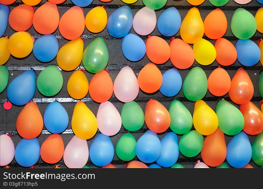 Many colorful balloons of various colors fo a background.