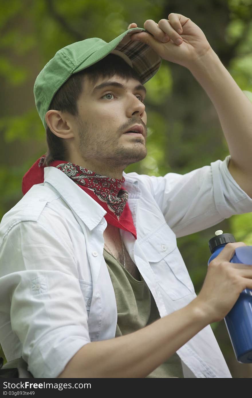 Male hiker traveling in forest with bottle water. Male hiker traveling in forest with bottle water