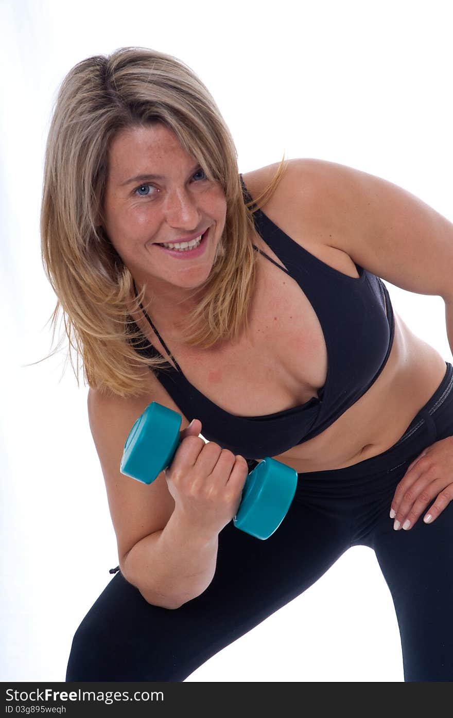 Active Woman doing exercises with dumbels