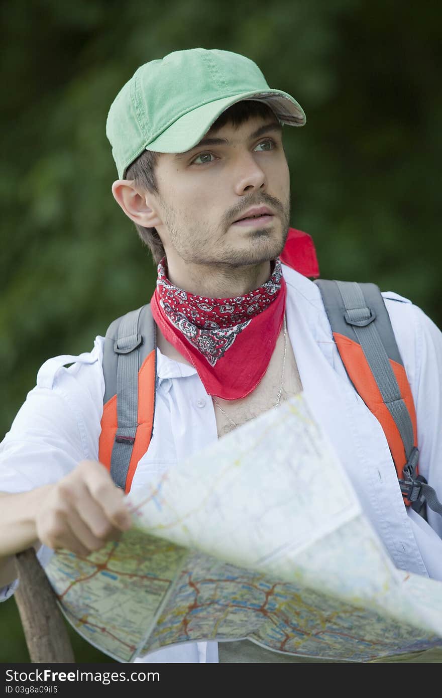 Hiker with map looking for the way