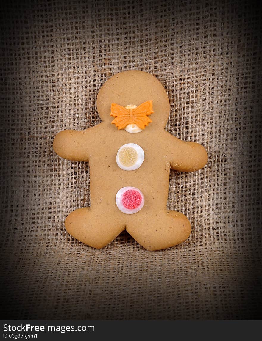 A Ginger Bread Man on a hessian background in a low light environment. A Ginger Bread Man on a hessian background in a low light environment.