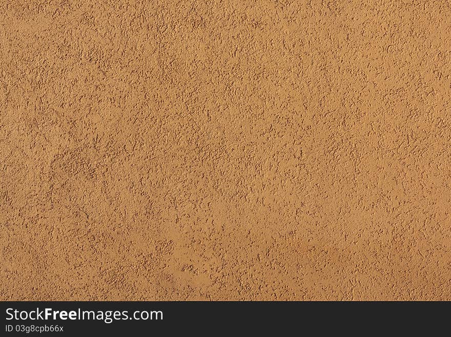 Close-up of yellow concrete wall illuminated by sunlight