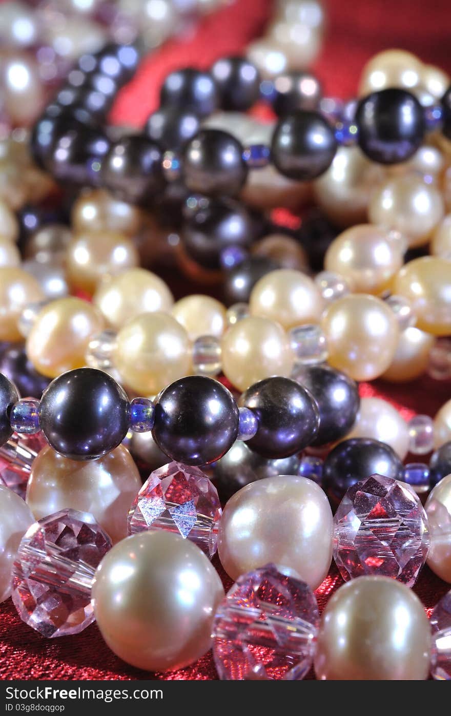 Pearl necklace on a red silk, close up