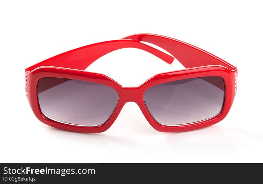 One red sunglasses on the white background. One red sunglasses on the white background