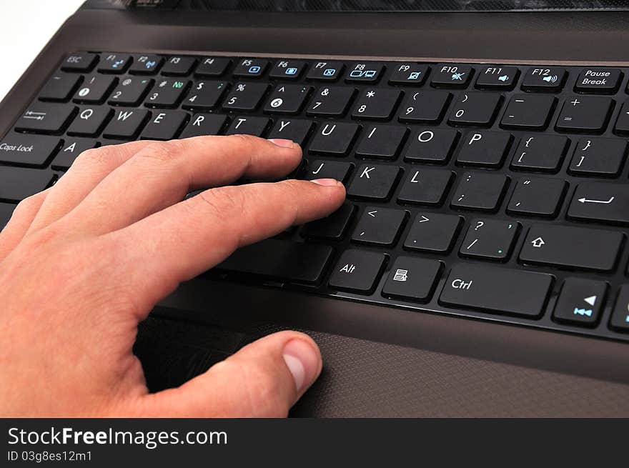 Hand on a laptop on a white background