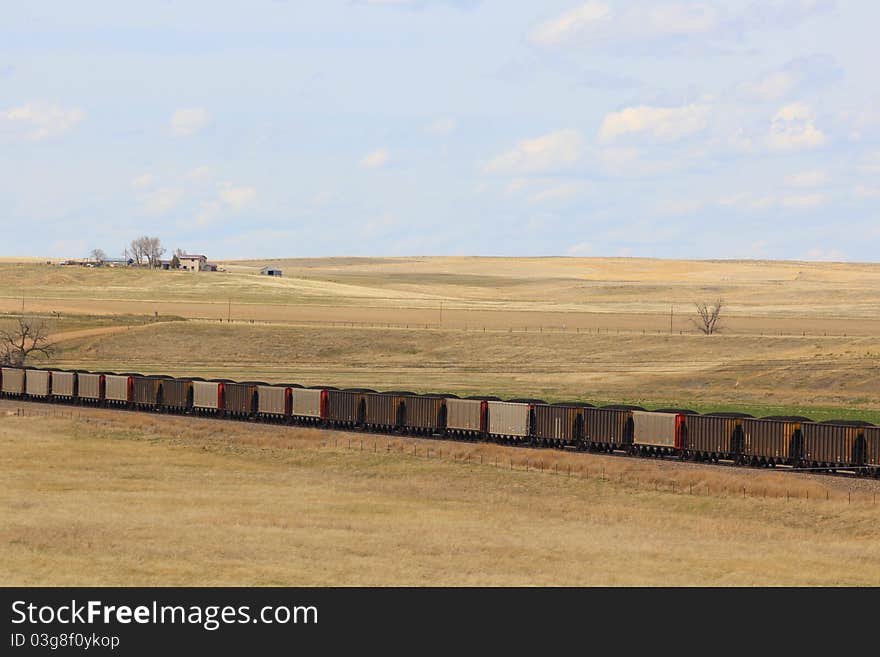 Coal train traveling across a prairie in Wyoming. Coal train traveling across a prairie in Wyoming.