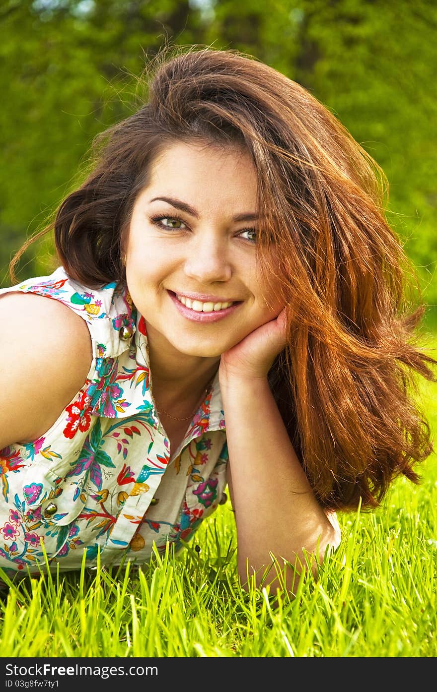 A beautiful young girl lying on the grass