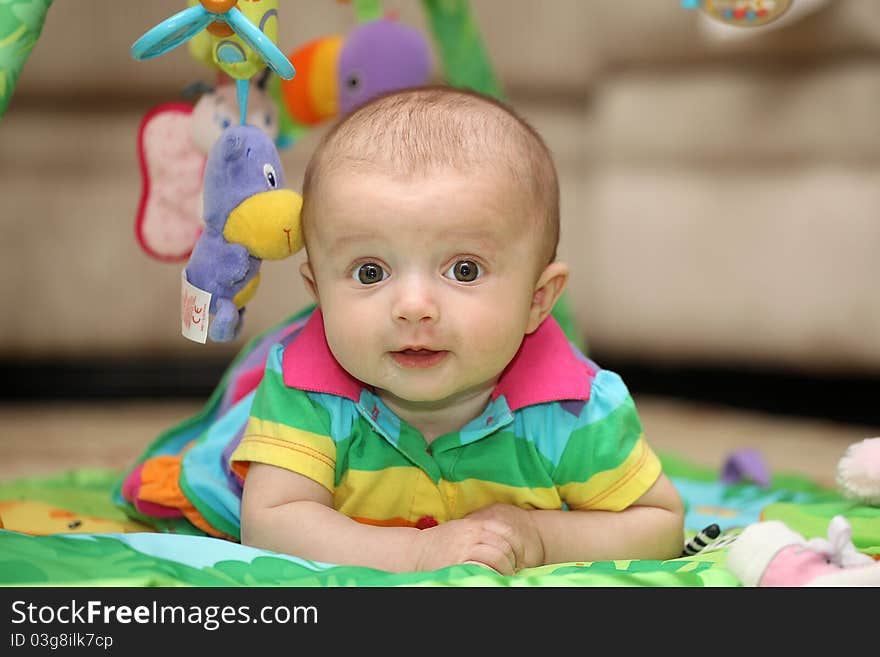 A little girl laying on her stomach. A little girl laying on her stomach