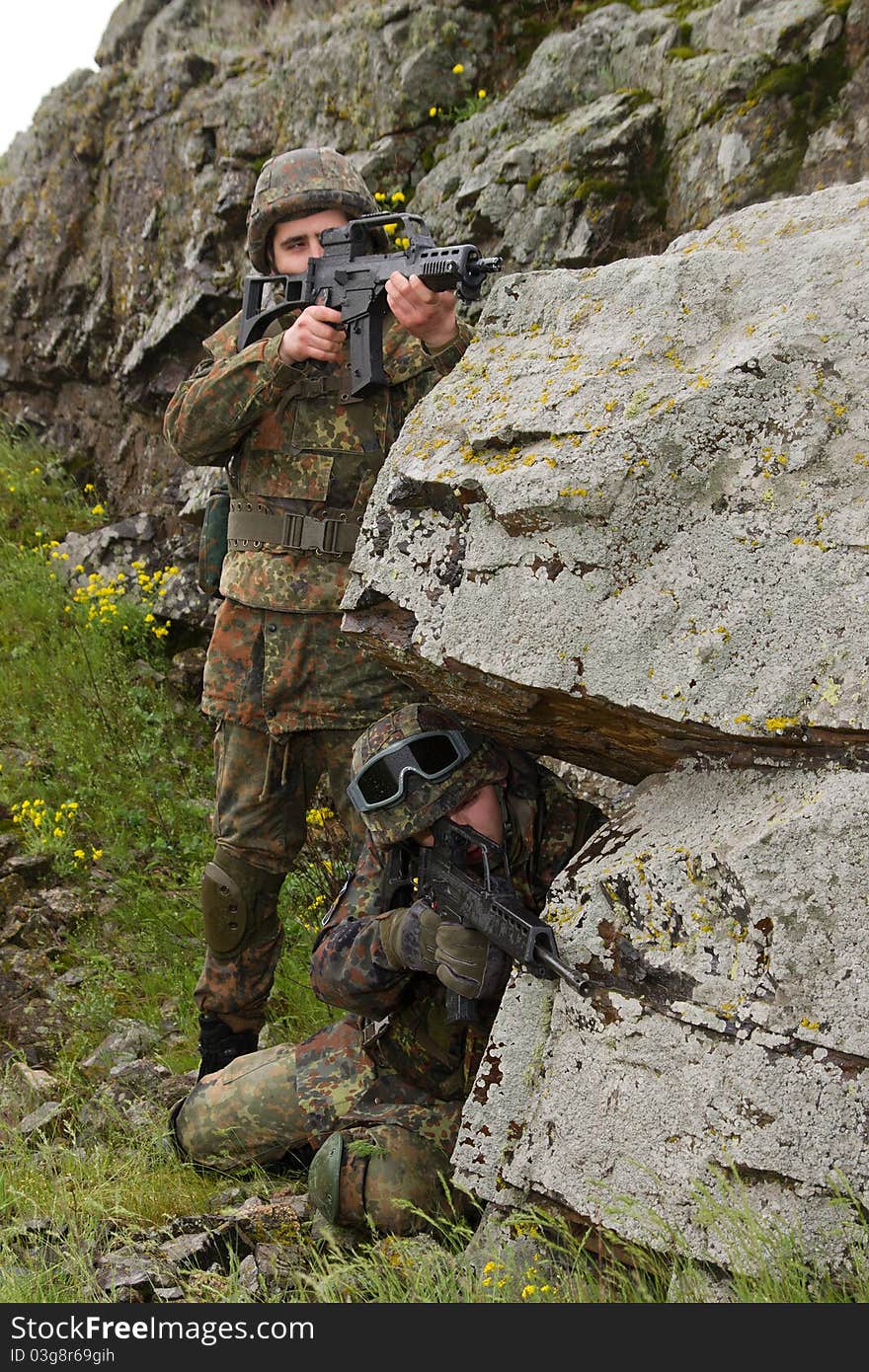 Two Soldiers Covering Behind The Rock